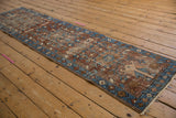 Heriz rug runner, central medallion with blue and brown checkered outline and varied patterns.