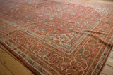 Detailed Herati pattern and intricate borders in burnt orange, beige, and blue on the Mahal rug.