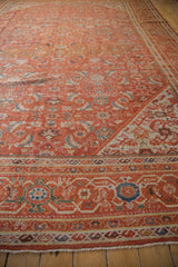 Vintage Mahal rug corner with burnt orange Herati pattern, detailed border, even wear.
