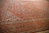 Vintage Mahal carpet with intricate borders and Herati design in burnt orange, blue, beige.