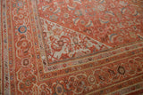 Vintage Mahal carpet corner detail: intricate Herati pattern in burnt orange, beige, and blue with abrashes.