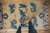 Antique Ningxia runner's pictorial cobalt Fu dog and apricot motif, seen with feet.