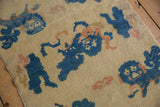 Antique Ningxia pictorial Fu dog motif in cobalt, apricot, and cream with even wear.