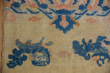Cobalt blue pictorial Fu dog motif and intact side selvage on an antique Ningxia rug.