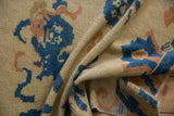 Textural pile of antique Ningxia rug in cobalt blue, apricot, and cream, showing folds.