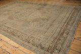 Distressed beige Oushak rug corner showing the pillared border design.
