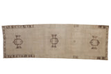Distressed Oushak runner, ivory field, three geometric brown medallions, vine border, 3' x 9'1
