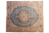 Distressed Turkish Sparta carpet with denim blue field, apricot, and ivory medallion.