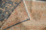 Distressed denim blue Sparta carpet pile showing wear, with hand-knotted apricot reverse.