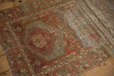 Close-up of distressed Oushak runner, showing worn pile, visible foundation, and faded red pattern.