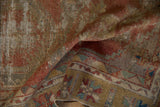 Textured worn pile of the distressed Oushak runner in muted red, gold, and beige.