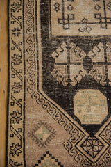Decorative texture of the distressed Oushak runner, highlighting geometric motifs and visible foundation.
