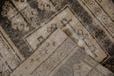 Distressed vintage Oushak rug folded, showcasing worn pile, exposed foundation, and hand-knotted reverse.