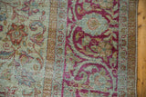 Distressed Mahal carpet detail, fuchsia vinery, seafoam green, with worn pile exposing foundation.