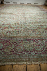 Distressed Persian Mahal carpet detail: raspberry fuchsia border with scrolling arabesques, seafoam green field.
