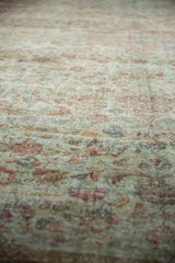 Distressed Mahal carpet pile, featuring soft seafoam green, raspberry, and dusty gold floral patterns.