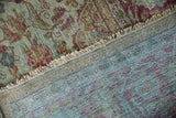 Distressed pile of vintage Mahal rug, revealing foundation and woven hand-knotted reverse.