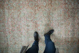 Worn texture and faded Herati design define this distressed vintage Mahal carpet in soft mauve and blue.