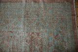 Distressed Persian Mahal carpet showcasing muted Herati pattern, worn pile, and exposed foundation.