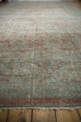 Distressed vintage Mahal carpet showing its muted mauves, blues, and intricate Herati pattern.