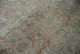 Worn pile texture of a distressed Mahal carpet with muted mauve and blue Herati design.