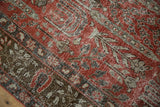 Worn pile texture of vintage Khoy rug, showing foundation and faded cinnabar red patterns.