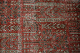Distressed Khoy carpet: cinnabar red field, oxidized silver botanical motifs, visible foundation.