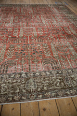 Distressed Khoy carpet: faded cinnabar field, stylized tree motifs, and chocolate brown border.