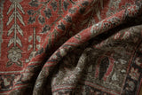Distressed Khoy carpet pile texture with garden motifs in cinnabar red and chocolate.