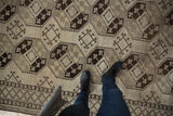 Distressed Ersari runner detail, dark brown and ivory geometric guls with checkered border.
