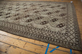 Distressed Ersari runner showcasing diamond checkered border and softened neutral tones.