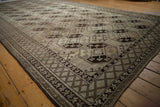 Distressed Ersari runner's main border: dark brown diamond checkered pattern with intersecting vines.