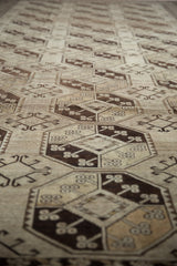 Afghani Ersari runner's distressed geometric gul motifs in dark brown and antique ivory.