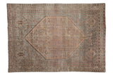 Distressed Kamseh carpet: hexagonal medallion, geometric motifs, dusty blue and mauve colors.