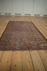 Vintage Distressed Belouch rug with softened terracotta and blue geometric panels.