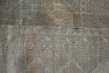 Vintage distressed Ersari rug showing subtle color variation, even pile wear, and detailed hand-knotted backing.