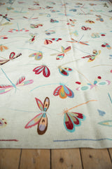 Replete multi-color dragonfly motifs on the ivory plain woven Pakistani Kilim.