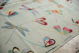 Plain woven texture of the pictorial kilim, featuring colorful dragonfly motifs.