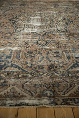 Distressed vintage Bakhtiari carpet pile showing beige, brown, and blue arabesque patterns with wear.