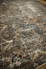 Distressed vintage Bakhtiari carpet pile revealing beige, indigo blue, and coffee brown patterns.