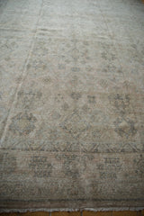 Distressed Amritsar rug with worn pile, visible foundation, faded floral designs, and muted tones.