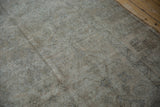 Distressed vintage Amritsar carpet with visible foundation, faint floral motifs, and muted ivory-beige tones.