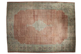 Distressed vintage Mahal carpet with faded copper field, diamond medallion, and wide sage green border.