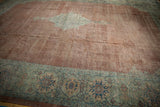 Distressed copper field texture and dusty sage green floral border on a vintage Mahal rug.