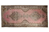 Vintage distressed Kars carpet runner with oversized medallions in blush pink, chocolate brown, and silver.