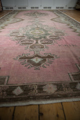Low-angle view showing the time-softened texture of a distressed pink Kars carpet runner.