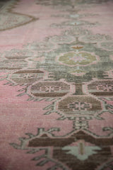 A low-angle view showing the distressed texture and worn pile of a vintage Kars runner.
