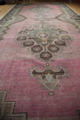 Low angle view of the distressed Kars runner's textured pile and abrashed pink field.