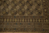 Distressed Afghani rug's geometric floral guls and intricate borders with coffee brown, dusty gold, navy.