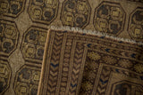 Vintage Distressed Afghani rug's worn geometric guls in dusty gold, coffee brown, with reverse side and fringe.